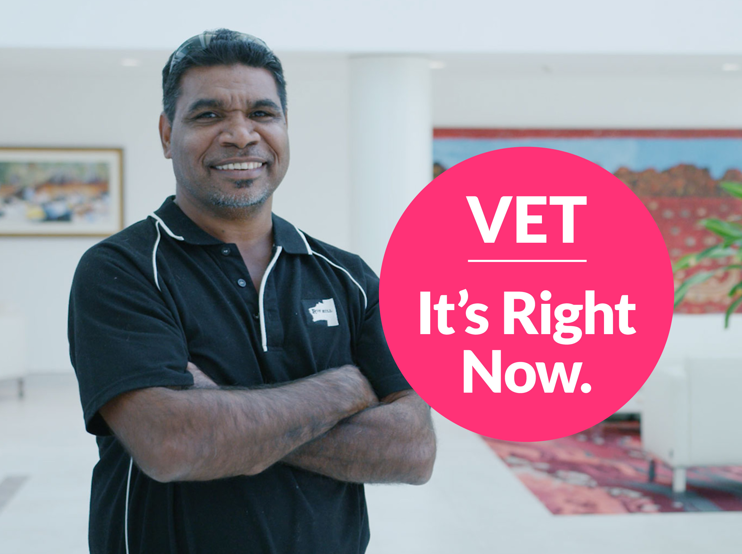 A First Nations man is smiling and standing with his arms folded. A pink graphic circle is in the foreground with the copy, 'VET: It's Right Now.'