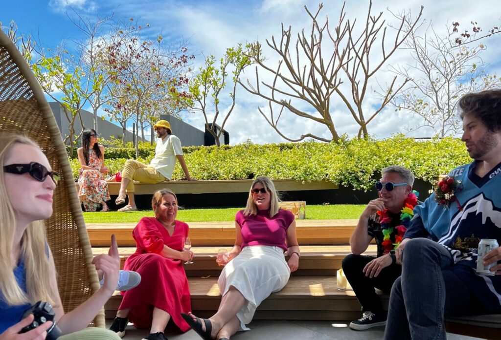 7 of the Anthologie team laid back on a rooftop garden at Christmas party.